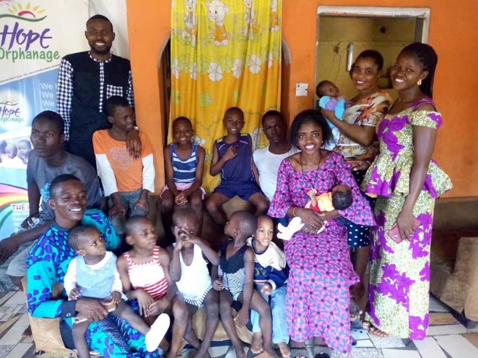 Volunteers holding babies and sitting with children